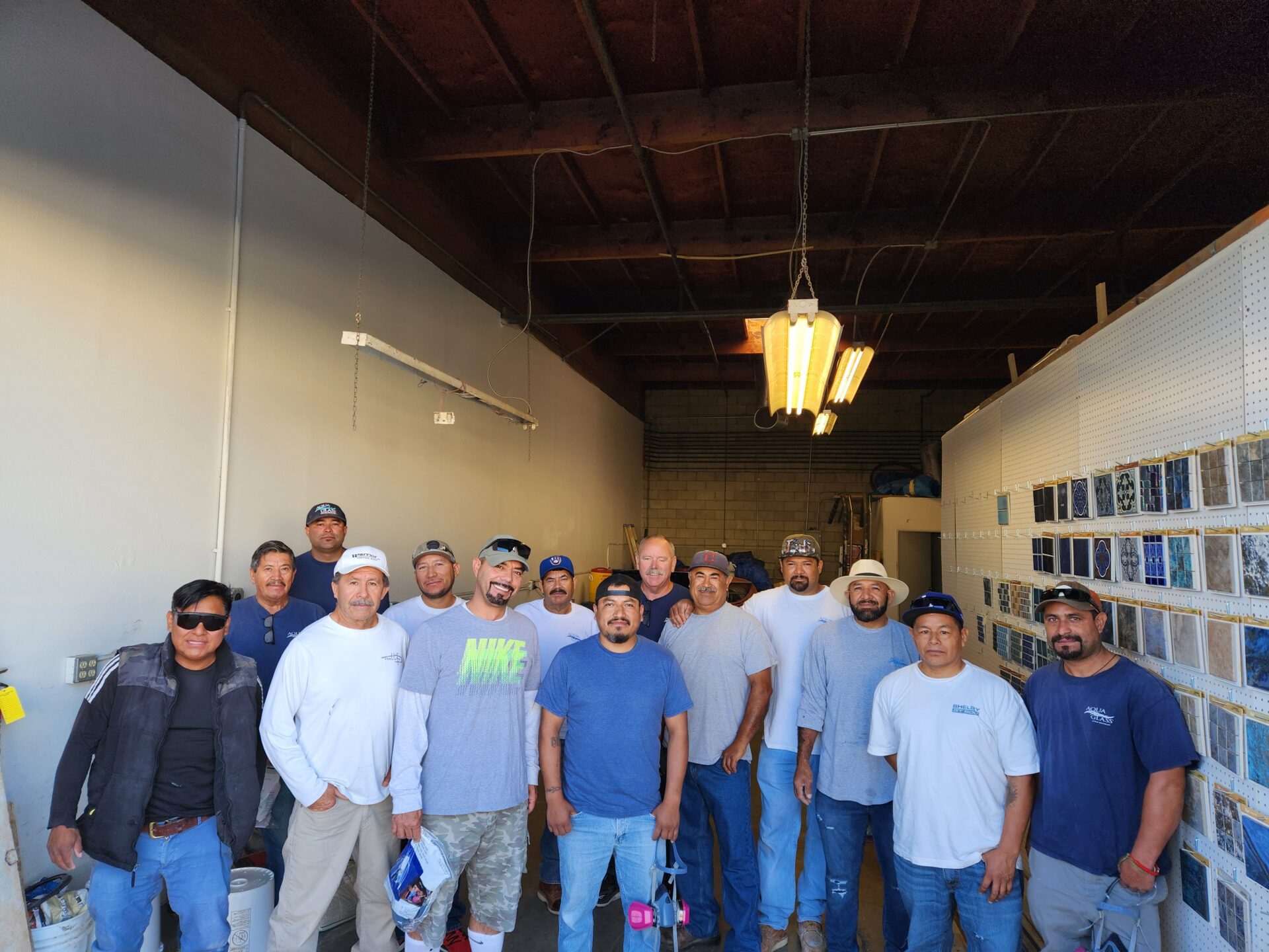 The Aqua Creations crew standing together inside the company shop